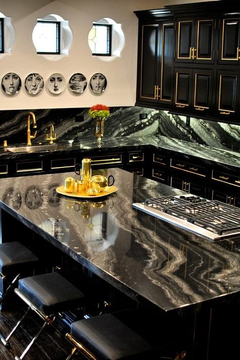black-kitchen-cabinets-gold-trim-fornasetti-plates-quatrefoil-windows